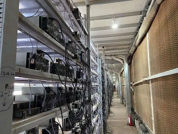 A close-up view of an ASIC miner with visible cooling fans and circuit boards, highlighting potential dust buildup issues